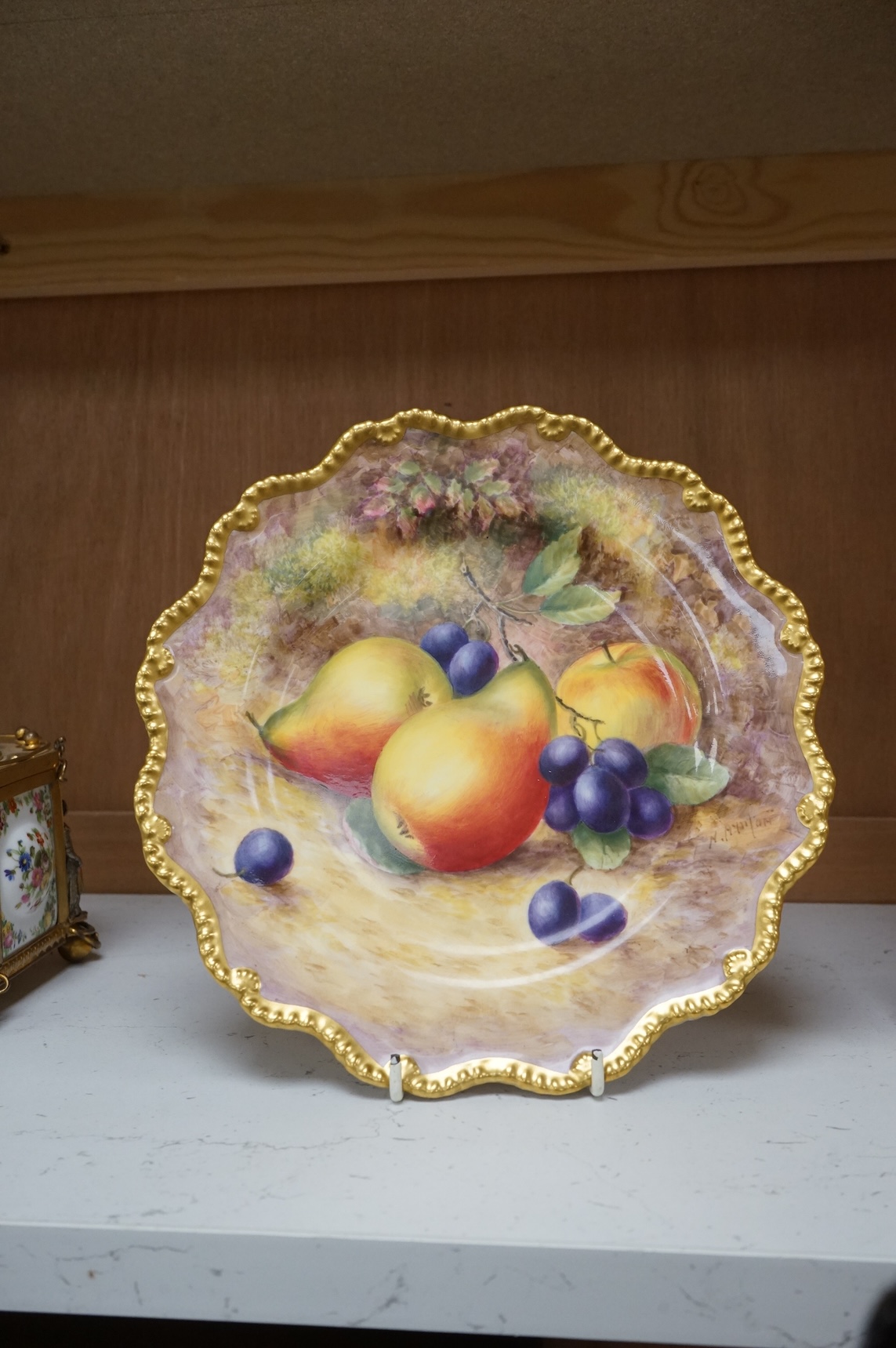 A Royal Worcester cabinet plate, painted with fruit by Harry Ayrton, signed, 22cm diameter.